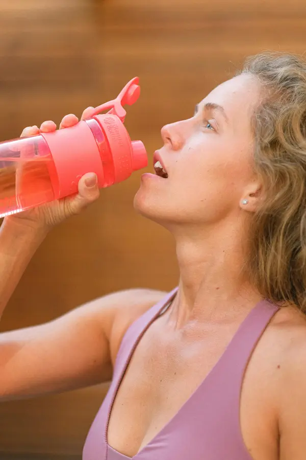 An athlete drinks water during training